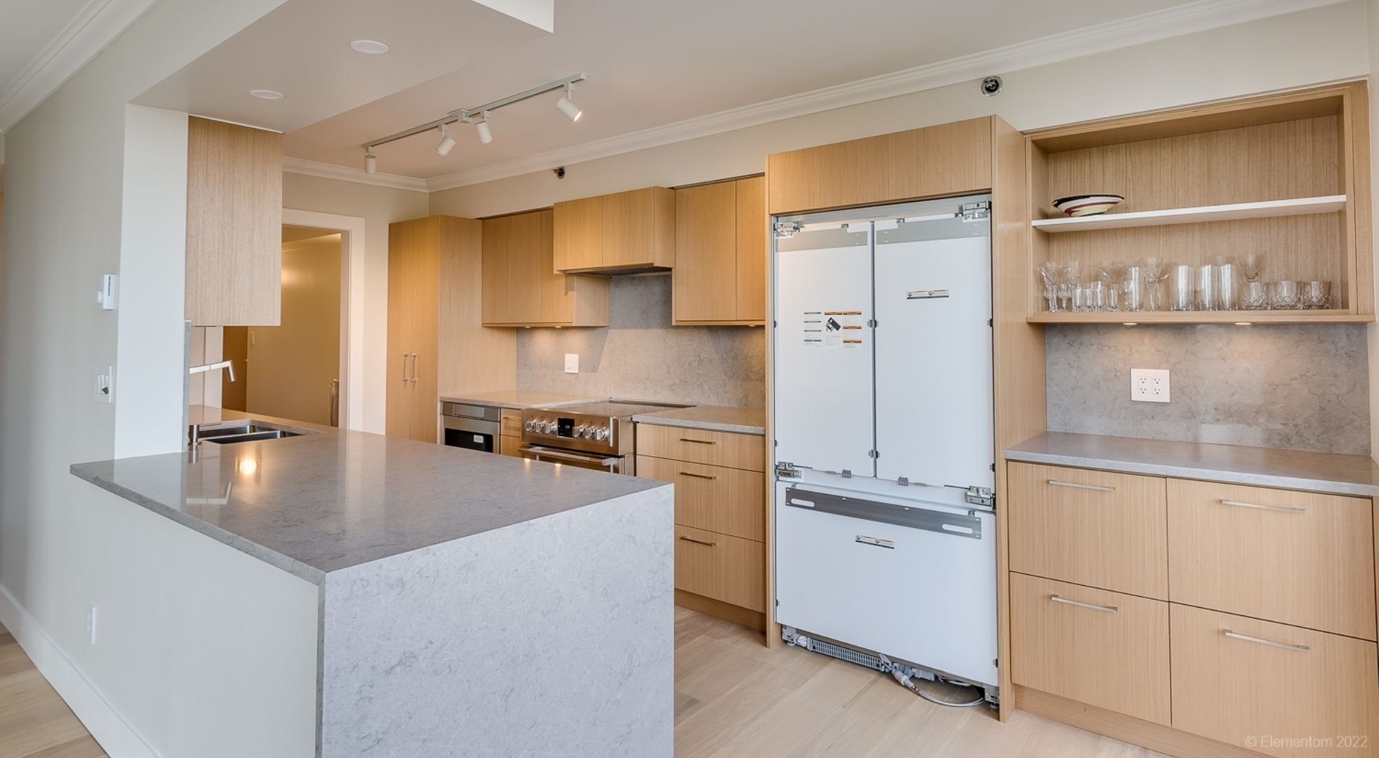 Bright kitchen renovation featuring wood cabinets, stone countertops, and open storage, Greater Vancouver - Optimized.