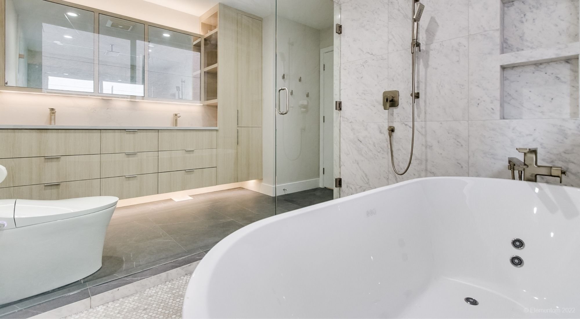 Primary bathroom with freestanding tub, marble shower, double vanity, and custom cabinetry + Greater Vancouver - opt