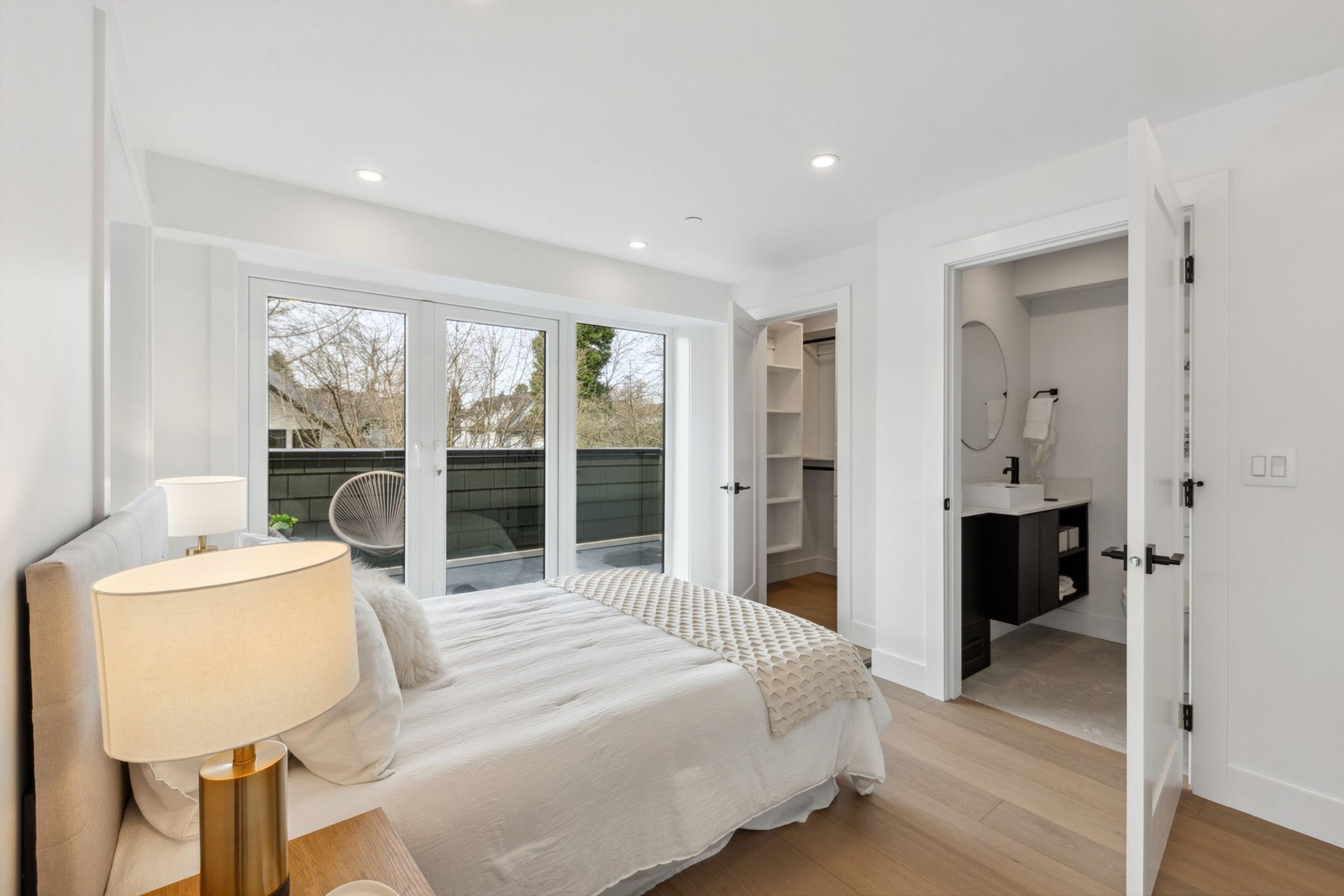 Vancouver bedroom with balcony doors, walk in closet, and ensuite bathroom