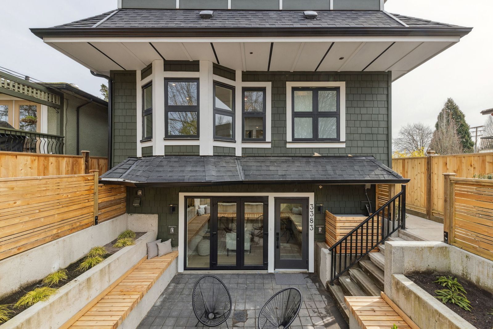 Vancouver home exterior with sunken patio and wood privacy fencing