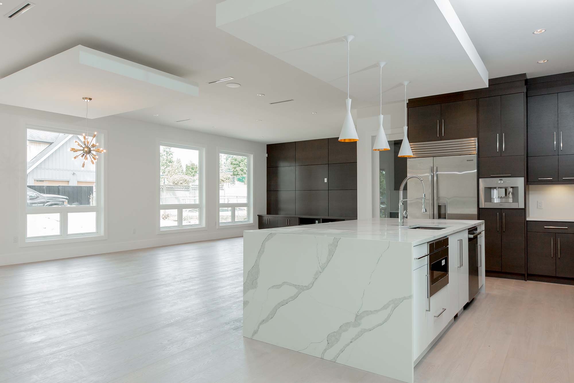 Kitchen and dining area with large waterfall island. Kitchen and dining area with large waterfall island.