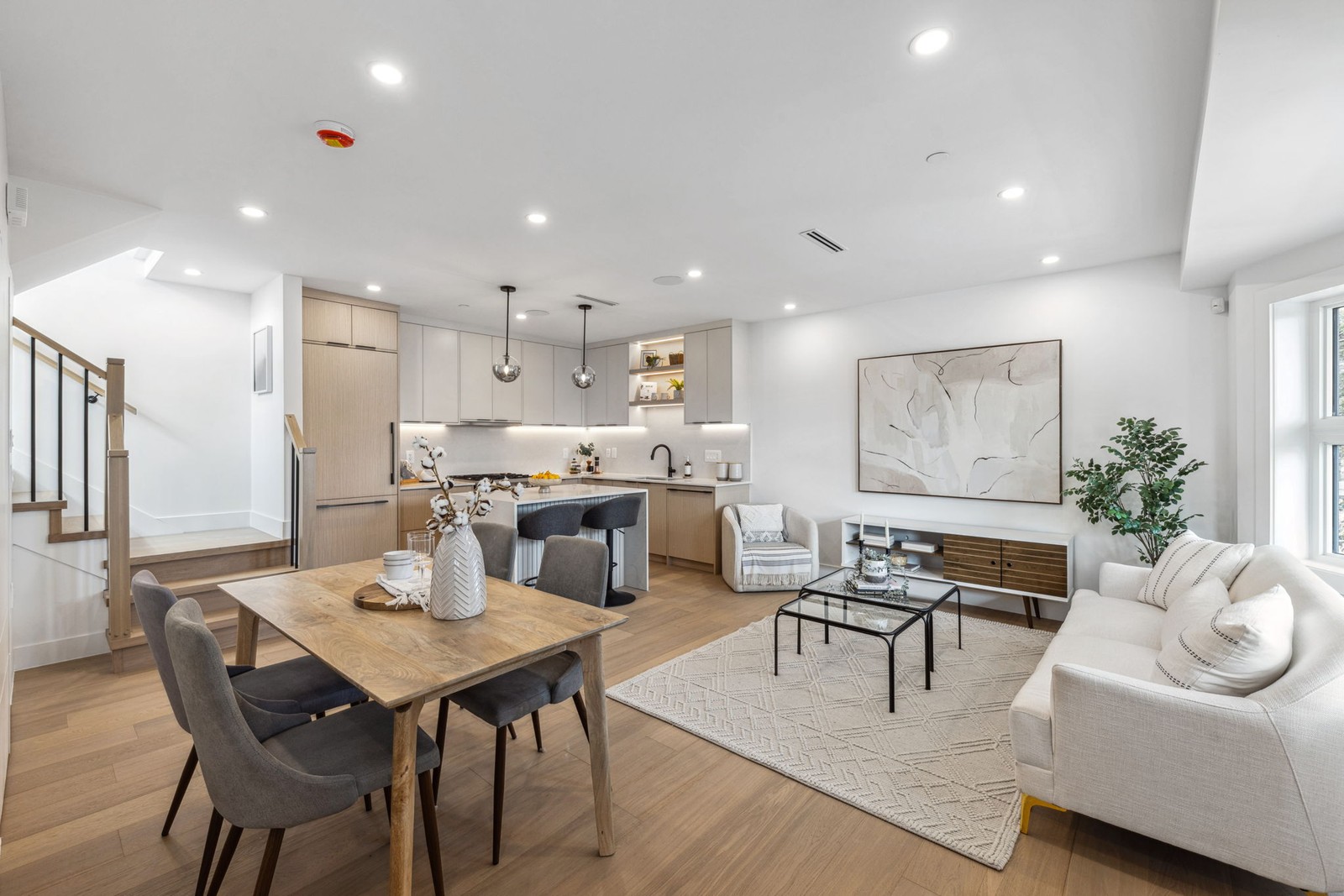 Open concept Vancouver kitchen, dining, and living room with pendant lighting